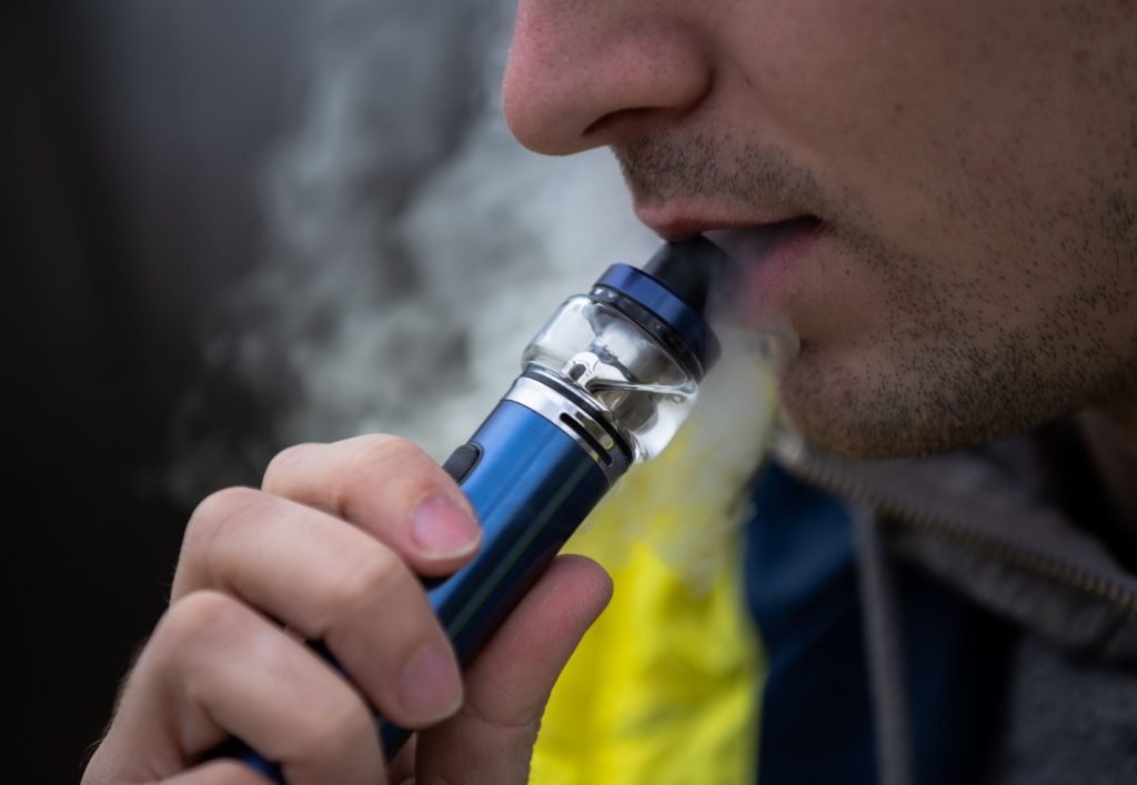 A person smoking a disposable-pod